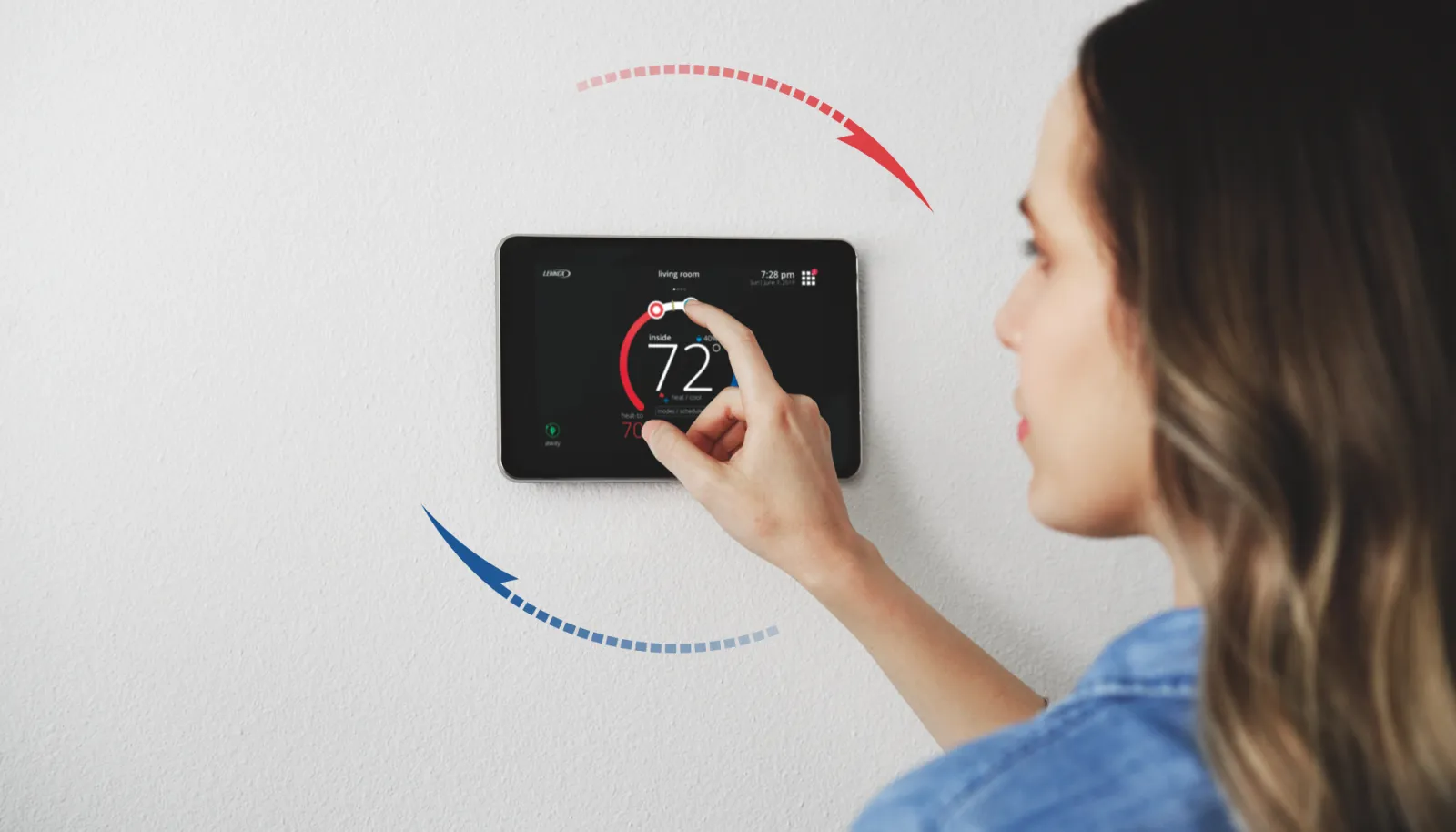 Homeowner adjusting a smart thermostat set to 72 degrees