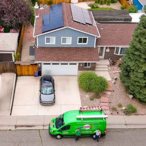 Cooper team installing solar panels on a home